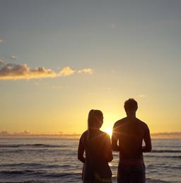 A photo of a mature dating couple looking watching the sunset